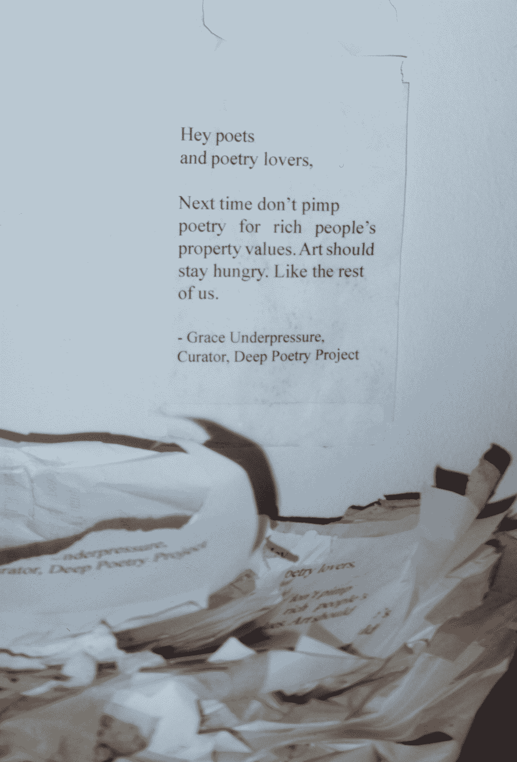 Sherry Smith worked really hard for half an hour ripping all these fliers off the sidewalk so nobody would about the curious origin of the so-called arts district